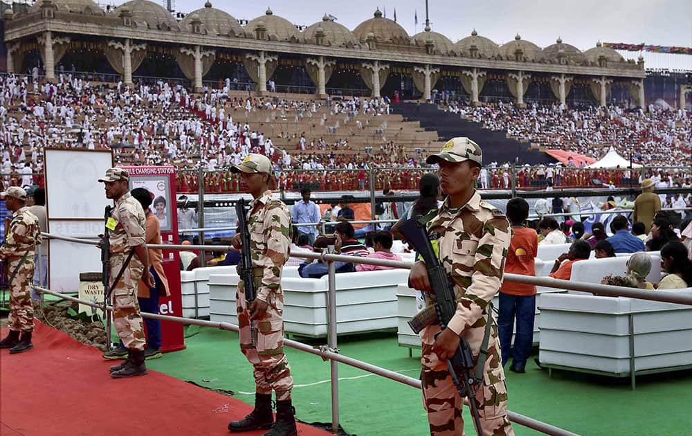 Security men stand guard during the opening day of the three-day long World Culture Festival on the banks of Yamuna River in New Delhi.