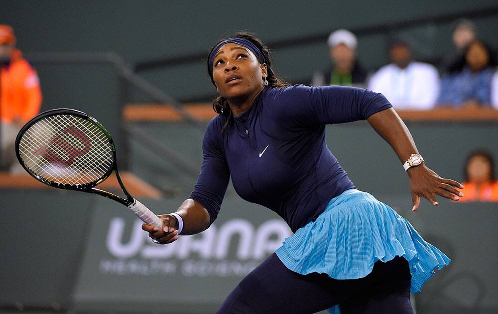 Serena Williams, of the United States, runs to return a shot from Laura Siegemund, of Germany, at the BNP Paribas Open tennis tournament.