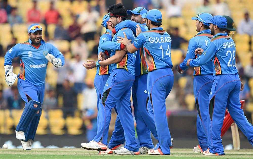 Afghanistan bowler Hamid Hasan celebrates with teammates after dismissing Zimbabwe batsman Hamilton Masakadza during the ICC World Twenty20 2016 cricket tournament in Nagpur.