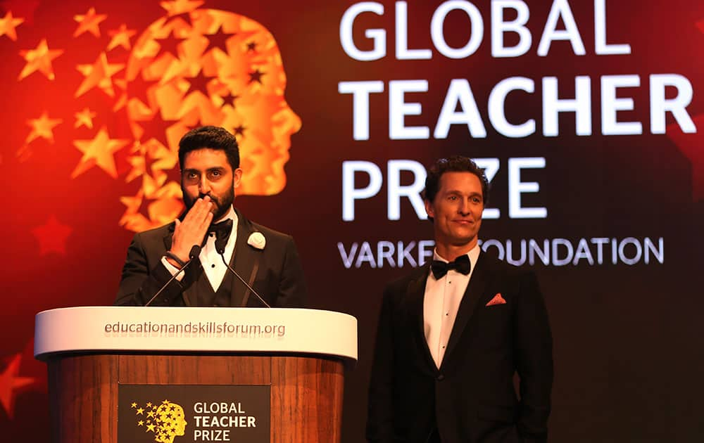 Bollywood actor Abhishek Bachchan, left stands next to Matthew McConaughey as he blows a kiss to the audience during a ceremony awarding the Global Teacher Prize, in Dubai, United Arab Emirates.