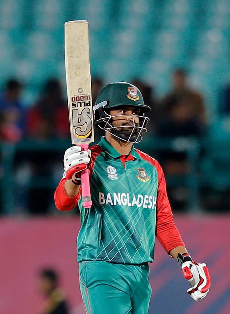 Bangladesh's Tamim Iqbal acknowledges his fifty runs during the ICC World Twenty20 2016 cricket tournament against Oman at the Himachal Pradesh Cricket Association (HPCA) stadium in Dharamsala.