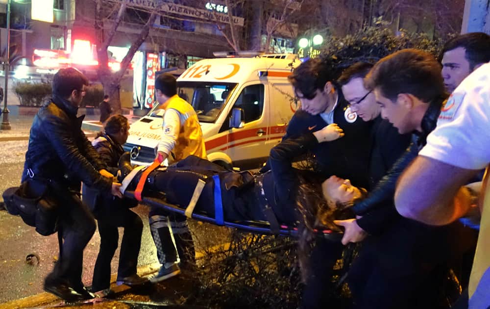 Medics carry an injured at the explosion site in the busy center of Turkish capital, Ankara