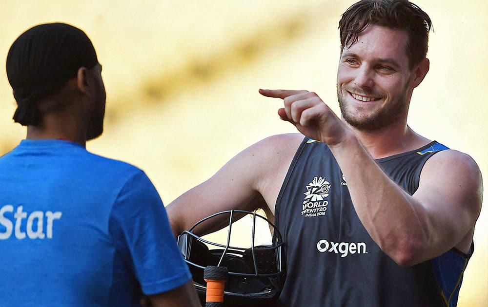 New Zealands Mitchell Mcclenaghan and Indian spinner Harbhajan in conversation during a practice session in Nagpur.