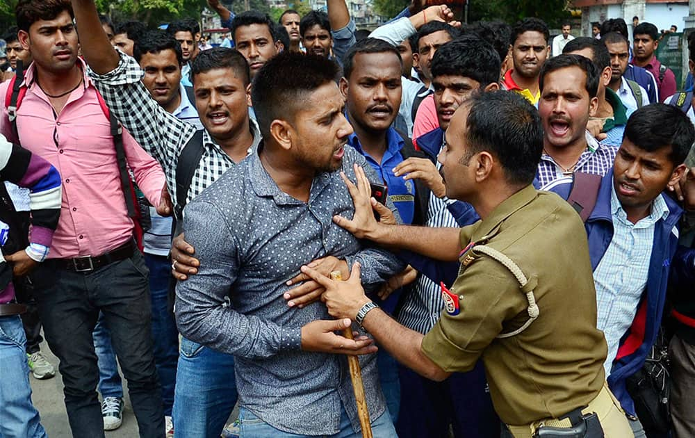 Police detain students during their protest demanding CBI investigation into the corruption in Staff Selection Commission recruitment 2011, in Allahabad.