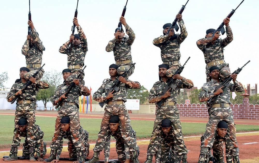 Armed guards of Sema Suraksha Bal (SSB) perform during a passing out parade in Jamnagar.