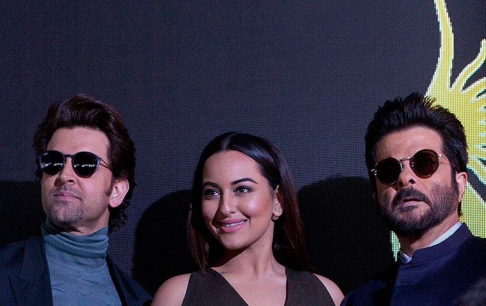 Bollywood actors Hrithik Roshan, left, Sonakshi Sinha, centre and Anil Kapoor, right, pose for photographers before the press conference for the 17º Edition of IIFA Weekend & Awards in Madrid, Spain. 