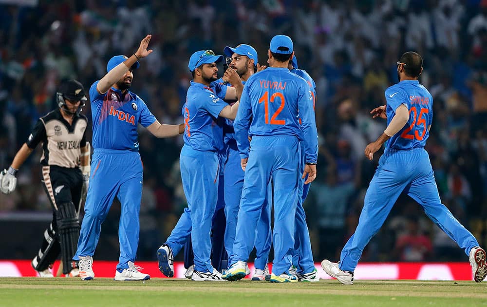 Indians celebrate the wicket of New Zealand's Martin Guptill during the ICC World Twenty20 2016 cricket match at the Vidarbha Cricket Association stadium in Nagpur.