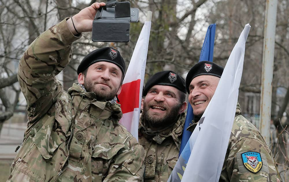 Officers of the Georgian National Legion volunteer battalion make a selfie prior to their departure to the area of the war conflict in Ukraines east, in Kiev, Ukraine.
