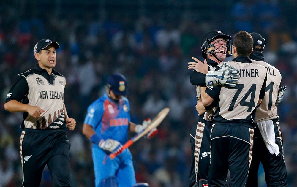 New Zealand players celebrate the wicket of India's Suresh Raina during the ICC World Twenty20 2016 cricket match at the Vidarbha Cricket Association stadium in Nagpur.