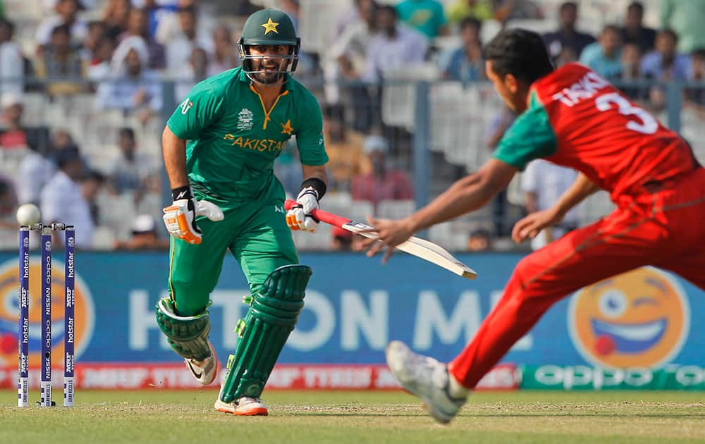 Pakistan's Ahmed Shehzad scores a run as Bangladesh's Taskin Ahmed tries to collect the ball during their match of the ICC World Twenty20 2016 cricket in Kolkata.