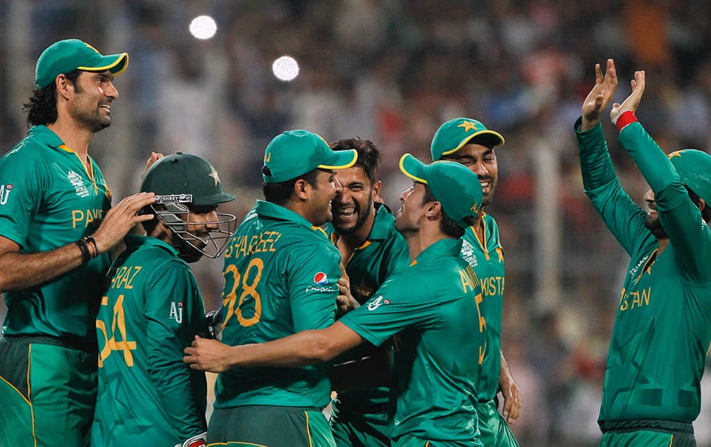 Pakistan players celebrate after Sharjeel Khan took a catch to dismiss Bangladesh's Mahmudullah during their ICC World Twenty20 2016 cricket match in Kolkata.