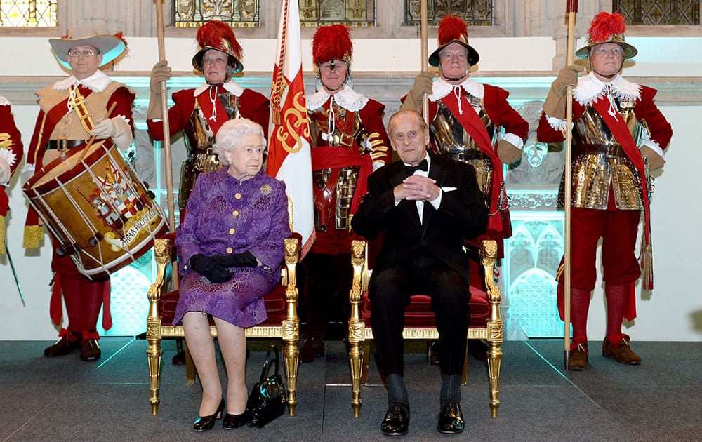 Britain's Queen Elizabeth and Prince Philip take a seat at a reception to mark Commonwealth week, at the Guildhall in London.