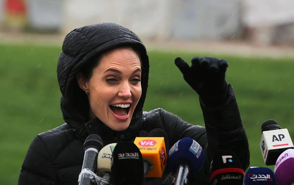 U.S. actress Angelina Jolie, Special Envoy of the United Nations High Commissioner for Refugees, waves to Syrian children during a press conference during her visit to a Syrian refugee camp, in the eastern city of Zahleh, Lebanon.