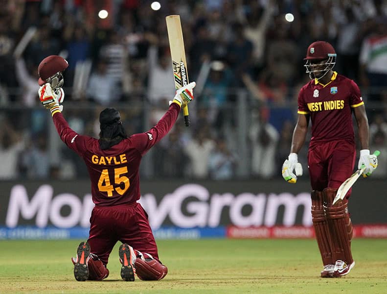 West Indies’ Chris Gayle raises his bat after scoring hundred runs against England during their ICC World Twenty20 2016 cricket match at the Wankhede stadium in Mumbai.