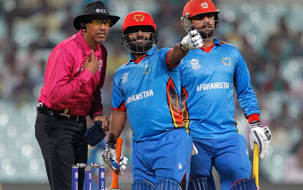 Afghanistan’s Shahzad Mohammad points out an issue to umpire Joel Wilson during their match against Sri Lanka at the ICC World Twenty20 2016 cricket tournament in Kolkata.