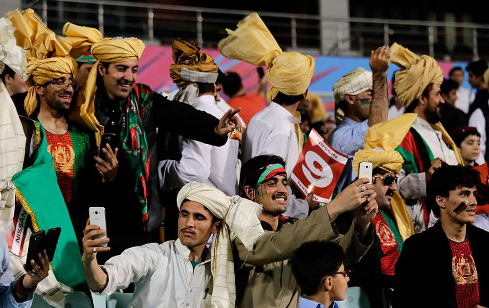 Afghan nationals in their traditional costumes gather to support their team against Sri Lanka at the ICC World Twenty20 2016 cricket tournament in Kolkata.