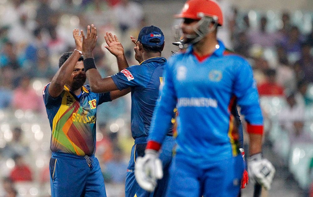 Sri Lanka's Rangana Herath is congratulated by a teammate after dismissing Afghanistan’s Noor Ali Zadran during their match at the ICC World Twenty20 2016 cricket tournament in Kolkata.