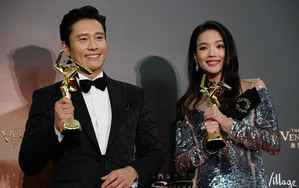 Taiwanese actress Shu Qi, right, and South Korean actor Lee Byung-hun pose after winning the Best Actress and Actor awards of the Asian Film Awards in Macau.