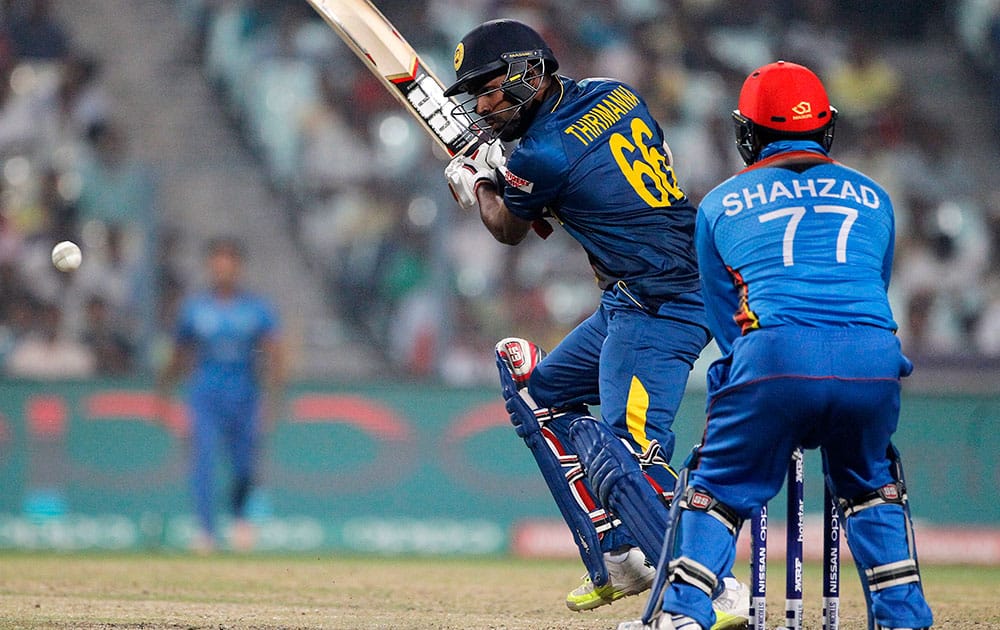 Sri Lanka's Lahiru Thirimanne plays a shot as Afghanistan's wicketkeeper Mohammad Shahzad watches during their match at the ICC World Twenty20 2016 cricket tournament in Kolkata.