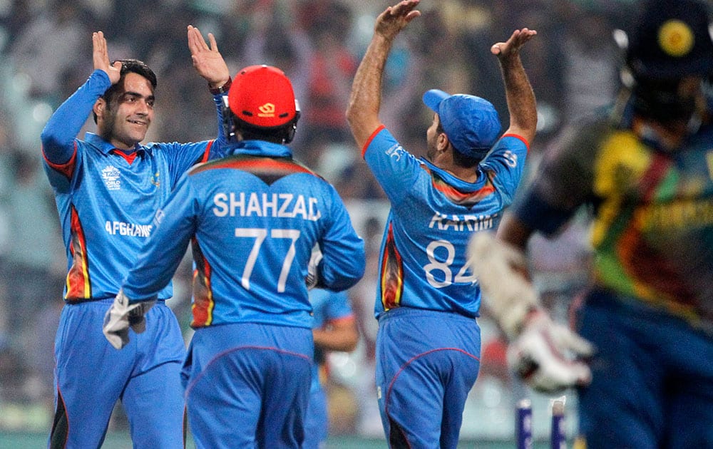 Afghanistan’s Rashid Khan celebrates with teammates after the dismissal of Sri Lanka's Lahiru Thirimanne during their match of the ICC World Twenty20 2016 cricket tournament in Kolkata.