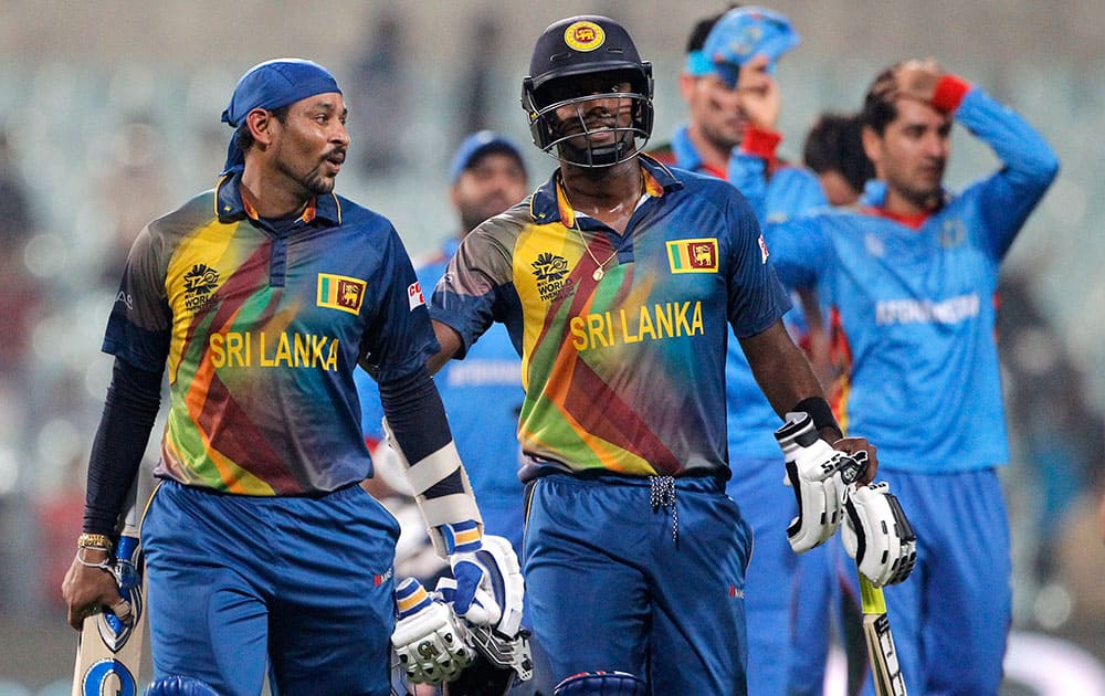 Sri Lanka's Angelo Mathews and Tillakaratne Dilshan walk from the field after they defeated Afghanistan by six wickets in their ICC World Twenty20 2016 cricket tournament in Kolkata.