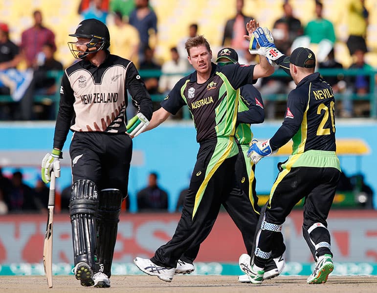 Australia's James Faulkner celebrates with teammate Peter Neville after dismissing New Zealand's Martin Guptill during their ICC World Twenty20 2016 cricket match at the Himachal Pradesh Cricket Association (HPCA) stadium in Dharamsala.