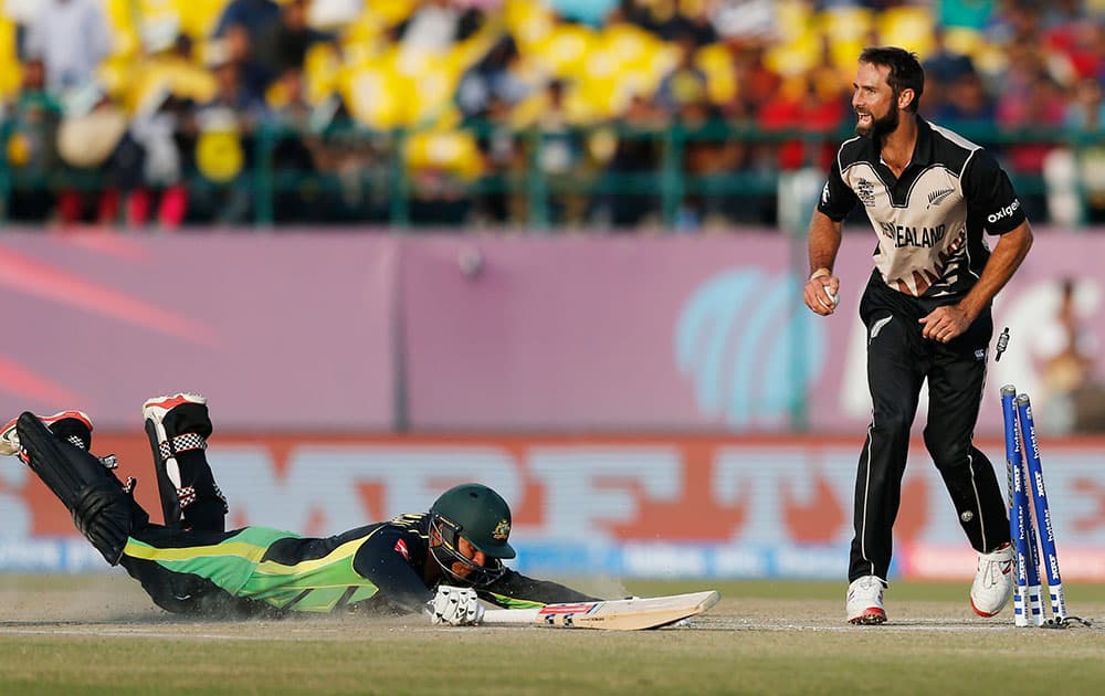 New Zealand's Grant Elliott reacts after running out Australia's Usman Khawaja during their ICC World Twenty20 2016 cricket match at at the Himachal Pradesh Cricket Association (HPCA) stadium in Dharamsala.