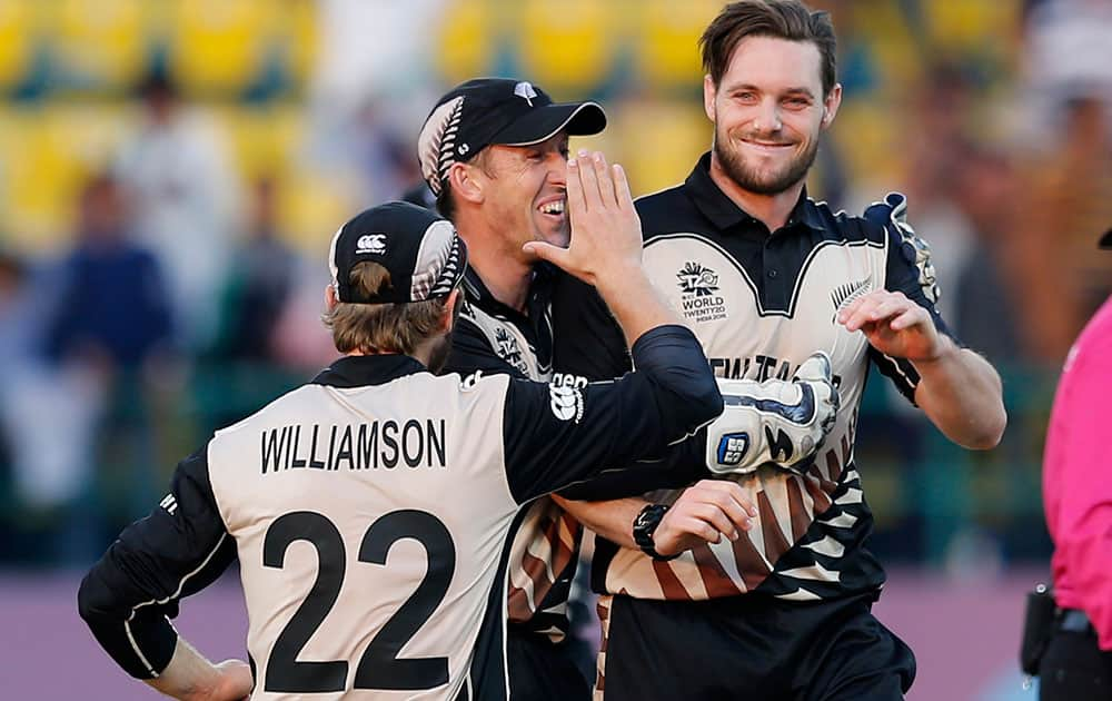 New Zealand's Mitchell McClenaghan is congratulated by teammates after taking a wicket against Australia during their ICC World Twenty20 2016 cricket match at the Himachal Pradesh Cricket Association (HPCA) stadium in Dharamsala.