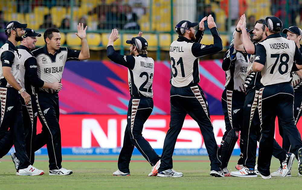 New Zealand players celebrate after defeating Australia by eight runs in their ICC World Twenty20 2016 cricket match at the Himachal Pradesh Cricket Association (HPCA) stadium in Dharamsala.