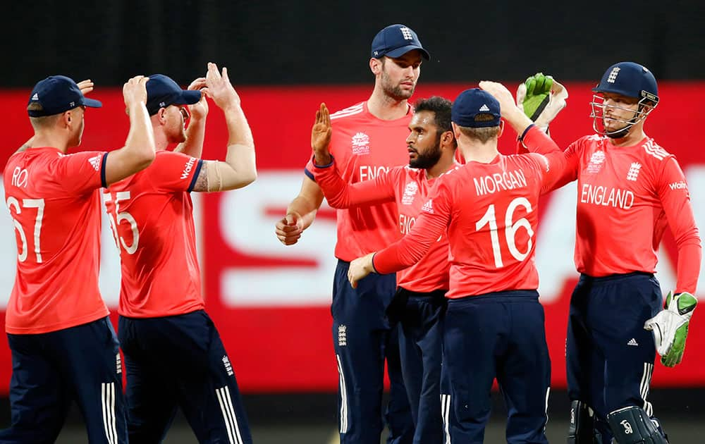 England's Adil Rashid is congratulated by teammates after taking the wicket of South Africa's AB de Villiers during their ICC World Twenty20 2016 cricket match at the Wankhede stadium in Mumbai.