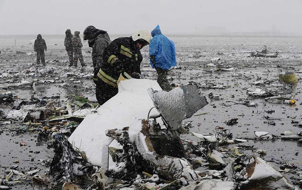 Russian Emergency Ministry employees investigate the wreckage of a crashed plane at the Rostov-on-Don airport, about 950 kilometers (600 miles) south of Moscow, Russia.