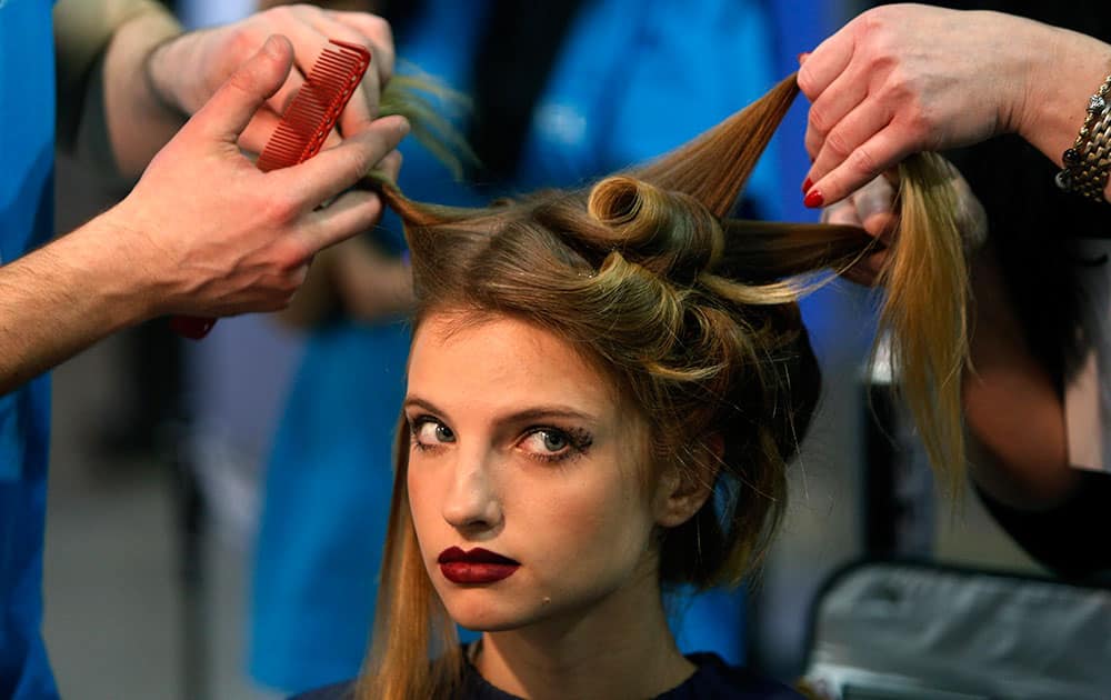 A model in the backstage area is made up prior to a show at the Fashion Week in Kiev, Ukraine.
