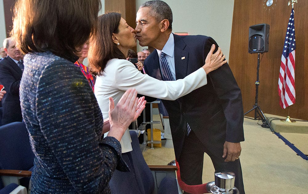 President Barack Obama stops to kiss Ambassador Pamela Hamamoto, Permanent Representative of the United States of America to the United Nations, after speaking at the Chief of Missions Conference in Dean Acheson Auditorium at the State Department in Washington.