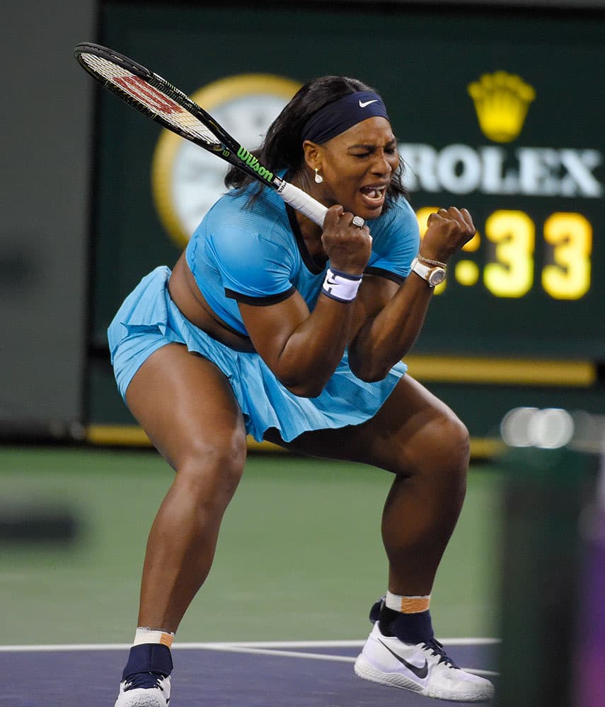 Serena Williams, of the United States, celebrates winning a point against Agnieszka Radwanska, of Poland, during a semifinal at the BNP Paribas Open tennis tournament.
