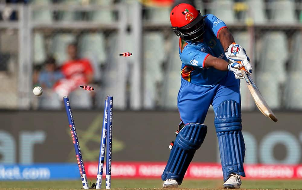 Afghanistan’s Mohammad Shahzad is bowled out by South Africa's Chris Morris during their ICC World Twenty20 2016 cricket match at the Wankhede stadium in Mumbai.