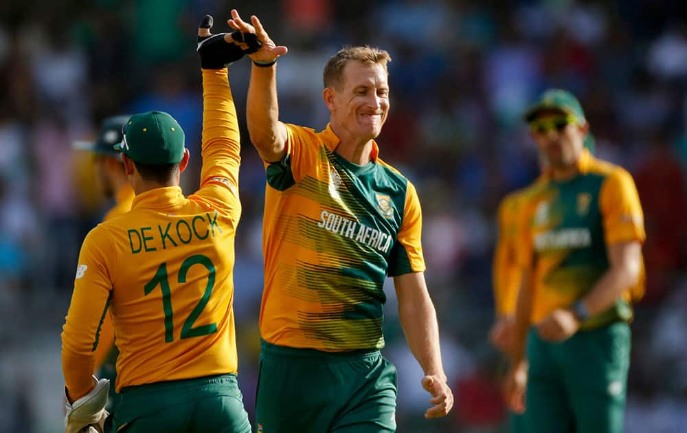 South Africa's Chris Morris, center, celebrates the wicket of Afghanistan's Shahzad Mohammadi'during their ICC World Twenty20 2016 cricket match at the Wankhede stadium in Mumbai.