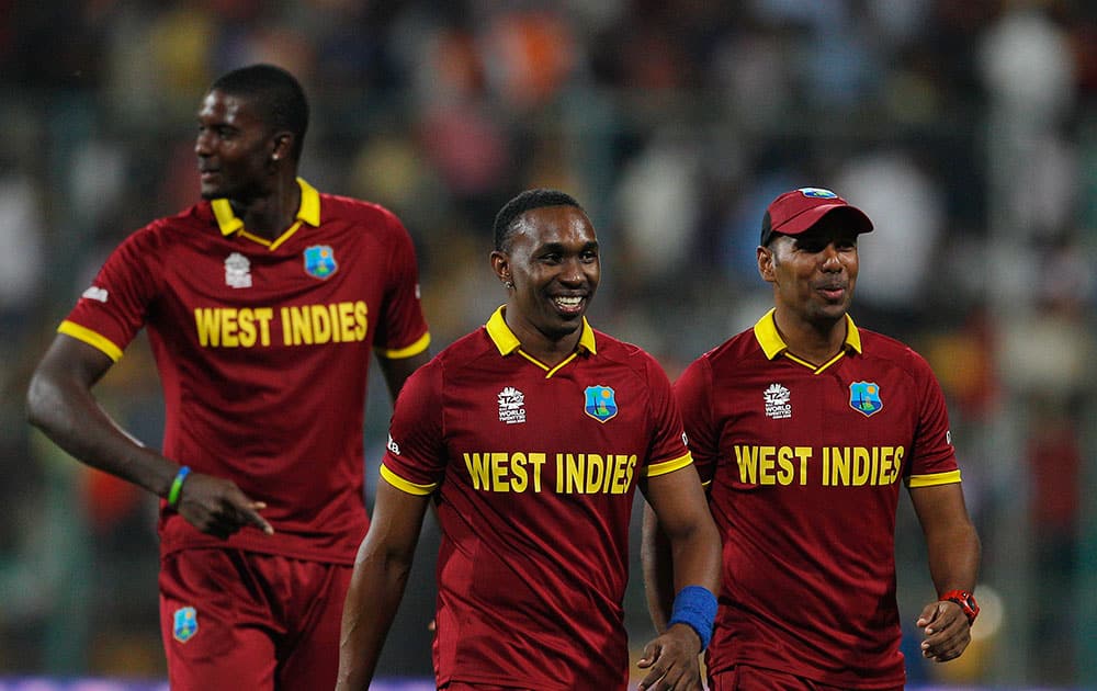 West Indies’ Dwayne Bravo, center, leaves the field with teammates Samuel Badree, right, and Jason Holder at the end of the first innings during their ICC World Twenty20 2016 cricket match against Sri Lanka in Bangalore.