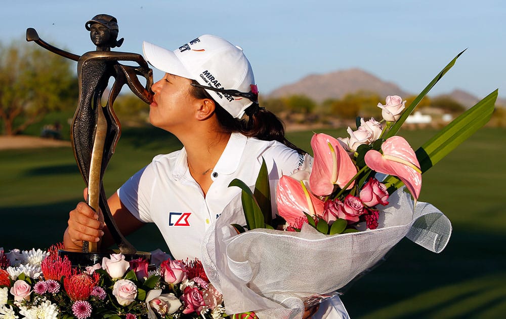 Kim Sei-young, of South Korea, kisses with the trophy after winning the JTBC Founders Cup golf tournament in Scottsdale, Ariz.