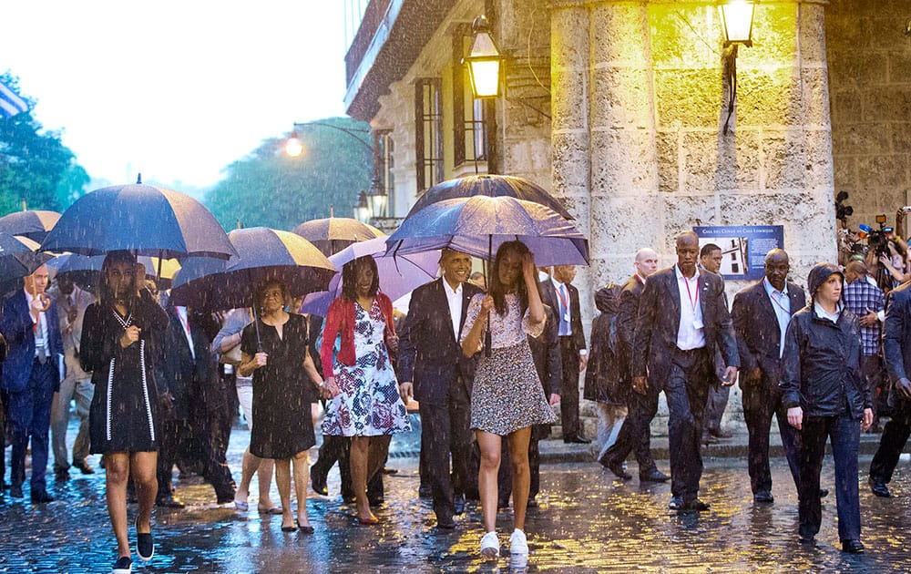 U.S. President Barack Obama, center, with his first lady Michelle Obama, daughters Malia and Sasha and first lady's mother Marian Robinson, take a walking tour of Old Havana in the rain, in Havana, Cuba.