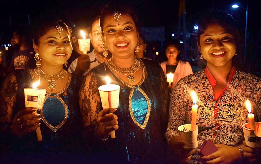 Girls and women take part in a candle march in support of Earth Hour organized by WWF-India Global Campaign at the Dighali Pukhuri Park in Guwahati.