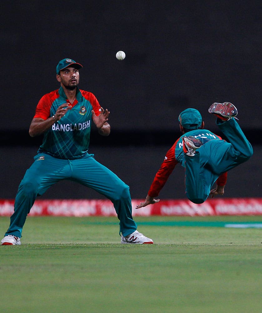 Bangladesh's captain Mashrafe Mortaza, left, watches the ball after teammate Mohammad Mithun, right, dropped the catch of Australia's Shane Watson during their ICC World Twenty20 2016 cricket match in Bangalore.