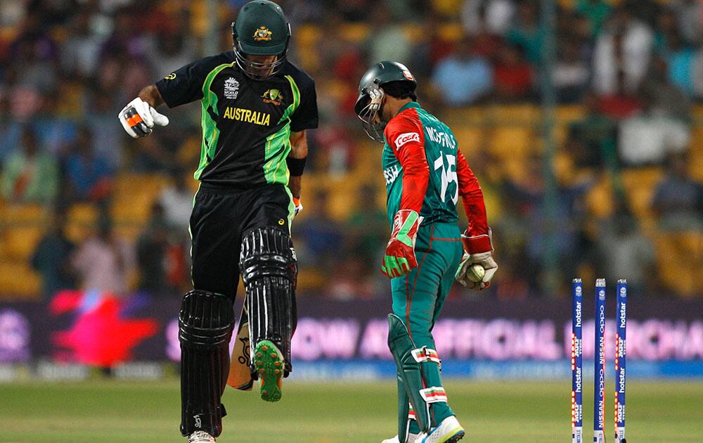 Bangladesh's Shakib Al Hasan, center, reacts as Australia's John Hastings, left, and James Faulkner run between the wickets during their ICC World Twenty20 2016 cricket match in Bangalore.