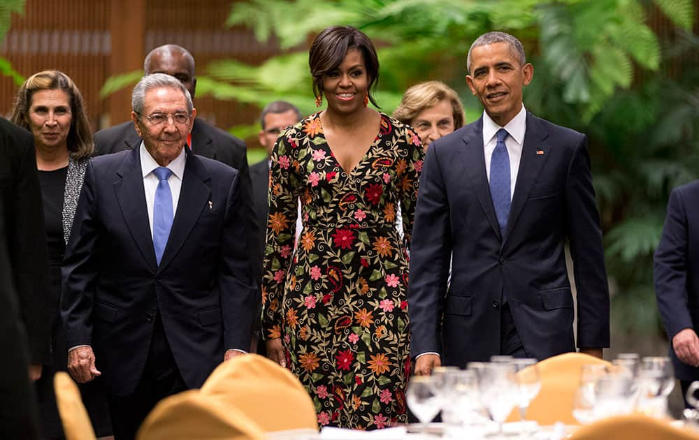 President Barack Obama, right, and first lady Michelle arrive for a state dinner with Cuba's President Raul Castro, left, at the Palace of the Revolution in Havana, Cuba.