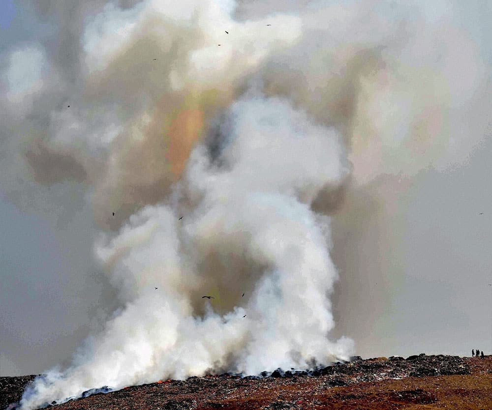 Smoke rises after a fire broke out at Deonar dumping ground in Mumbai.