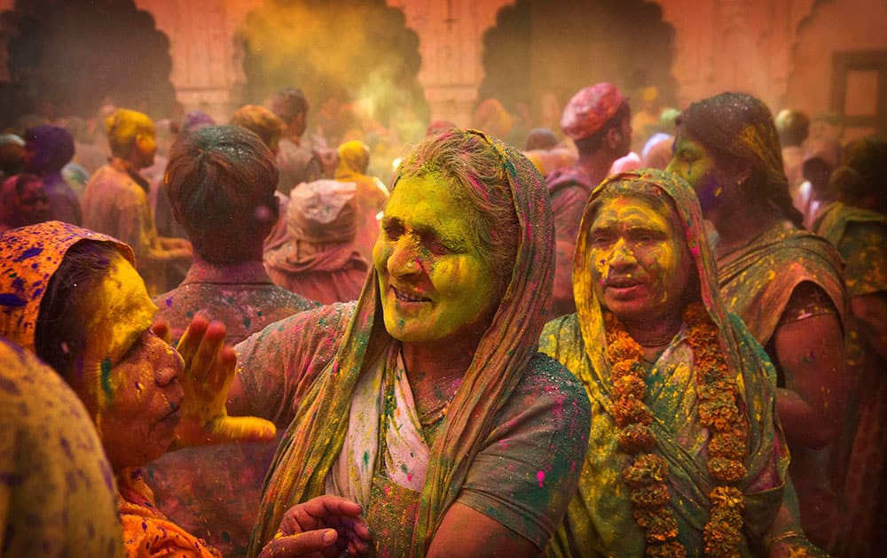 Hindu widows apply colour powder to each other during Holi celebrations at the Gopinath temple, 180 kilometres (112 miles) south-east of New Delhi.