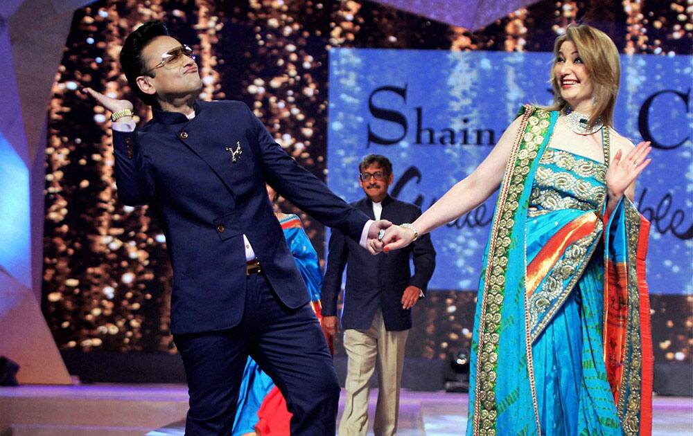 Musician and singer Adnan Sami walk the ramp during a fashion show in Mumbai.