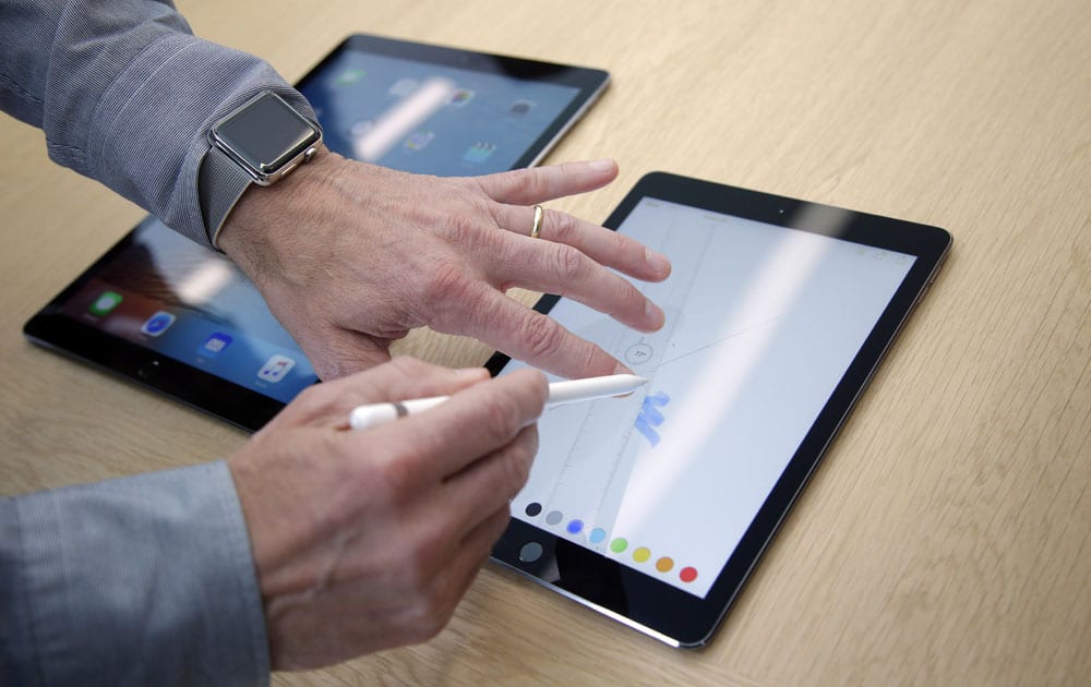 Members of the media and invited guests take a look at the new iPad Pro during an event at Apple headquarters Monday, March 21, 2016, in Cupertino, California.