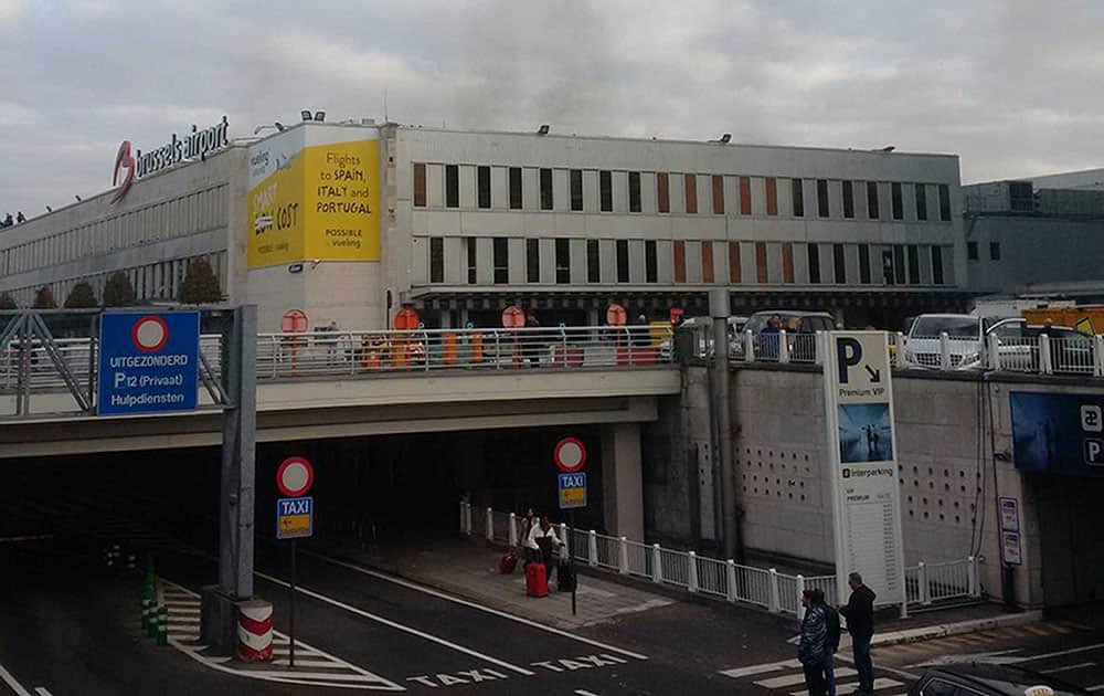 In this image provided by Daniela Schwarzer, smoke is seen at Brussels airport in Brussels, Belgium, after explosions were heard.