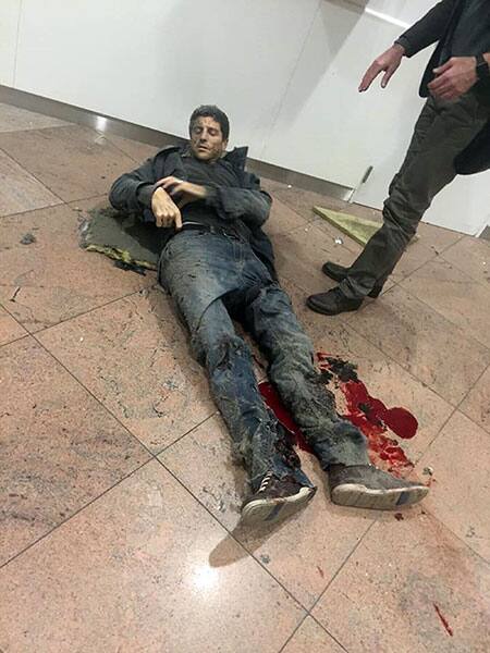 In this photo provided by Georgian Public Broadcaster and photographed by Ketevan Kardava a man is wounded in Brussels Airport in Brussels, Belgium, after explosions were heard.