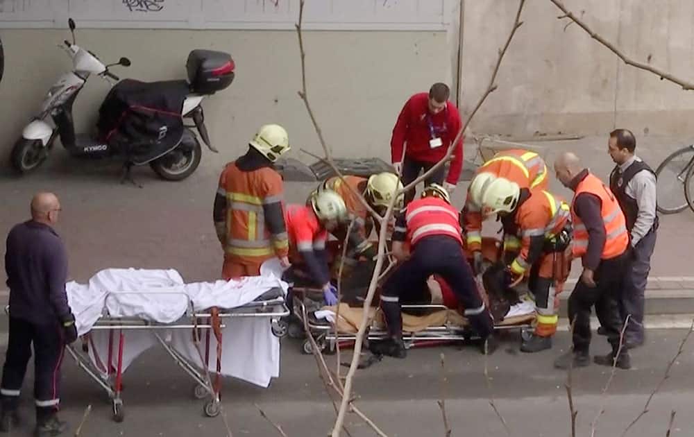 In this image made from video, emergency rescue workers stretcher an unidentified person at the site of an explosion at a metro station in Brussels, Belgium.